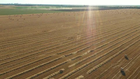Aerial view of tractor tow trailed bale machine to collect straw Stock Footage 300245601