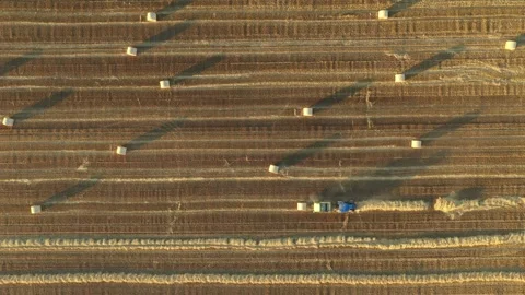 Aerial view of tractor tow trailed bale machine to collect straw Stock Footage 300247231