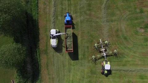Aerial view of a tractor with trailer on the field at the haymaking - germany Stock Footage 75865365