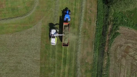Aerial view of a tractor with trailer on the field at the haymaking - germany Stock Footage 75865379