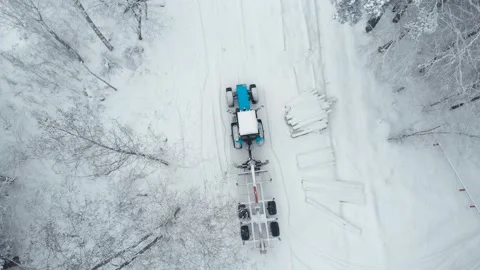 Aerial view a tractor with a trailer for loading logs rides Stock Footage 169549178