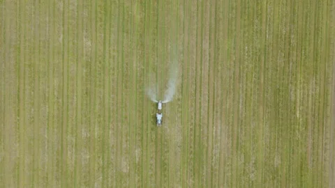 Aerial view of a tractor which Spraying chemical insecticide or fertilizers to Stock Footage 152999610