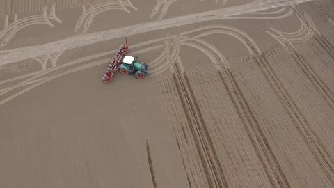 Aerial view of a tractor at work - cultivating a field in spring Stock Footage 74725977