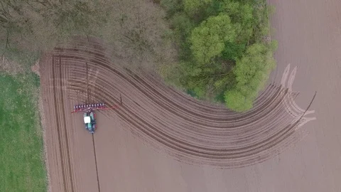 Aerial view of a tractor at work - cultivating a field in spring Stock Footage 74726005