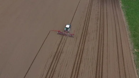 Aerial view of a tractor at work - cultivating a field in spring Stock Footage 74726983
