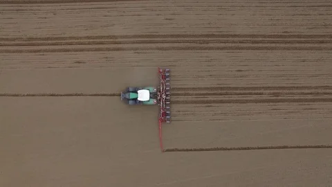 Aerial view of a tractor at work - cultivating a field in spring Stock Footage 74727032