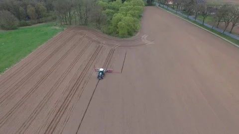 Aerial view of a tractor at work - cultivating a field in spring Stock Footage 74727588