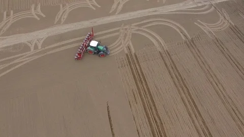 Aerial view of a tractor at work - cultivating a field in spring Stock Footage 74727611