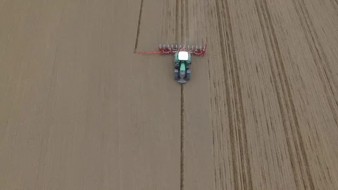 Aerial view of a tractor at work - cultivating a field in spring Stock Footage 74729353