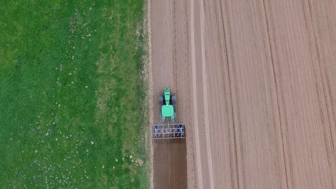 Aerial view of a tractor at work - cultivating a field in spring Stock Footage 74731007