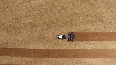 Aerial view of a tractor at work - tractor plough cultivating beautiful fields Stock Footage 74992826