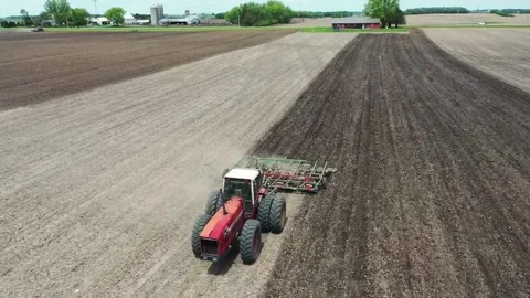 Aerial view of a tractor is working in a farm Stock Footage 203925061