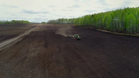 Aerial View of Tractor Working in Field, Crop Sowing. Wheat, Barley, Rye Seeding Stock Footage 127982643
