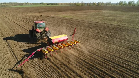 Aerial view of tractor working in the field Stock Footage 129055037