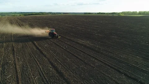 Aerial view of tractor working in the field with a modern sowing seeds machine Stock-Footage 129759622