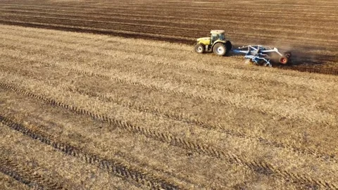 Aerial view of a tractor working in the field. Stockbeeldmateriaal 140900379
