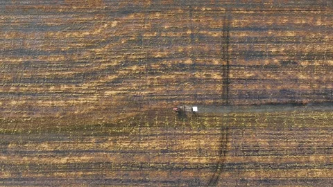 An aerial view of a tractor working in a field. Stock Footage 306138201