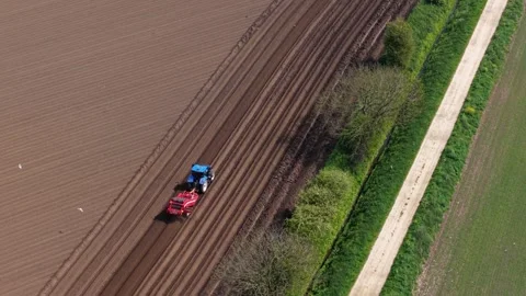 Aerial view of a tractor working in a field in Knottingley, United Kingdom. Stock Footage 334348639