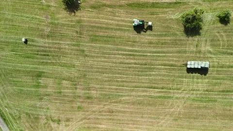 Aerial View of Tractor Working on Hay Field in Rural Countryside Vídeos de archivo 335647682