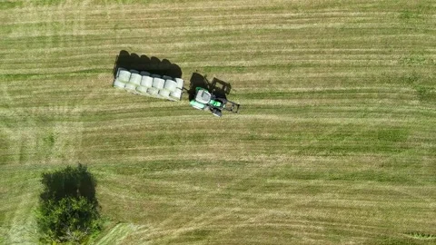 Aerial View of Tractor Working on Hay Field in Rural Countryside Vídeos de archivo 335647880