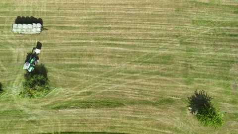Aerial View of Tractor Working on Hay Field in Rural Countryside Stock-Footage 335647918