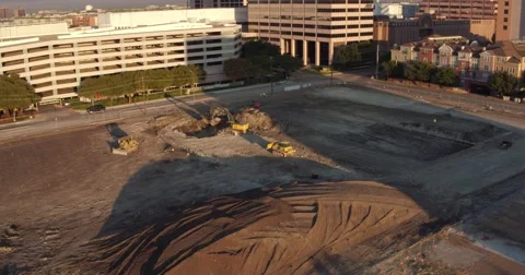 Aerial view of tractors digging a hole on a construction site in Dallas, Texas. Stock Footage 60793527