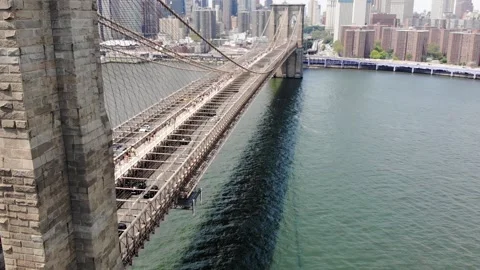 Aerial View of Traffic on Brooklyn Bridge with Bird and Cityscape in Slow Motion Stock Footage 142308778