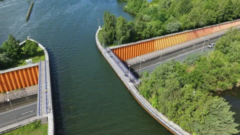 Aerial view of traffic driving through the Veluwemeer Aqueduct with water Stock Footage 338014138