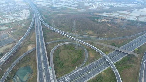 Aerial view of traffic on elevated freeway at intersection city suburbs, CHINA Stock Footage 75872259