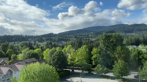 Aerial view of traffic flow and parking lot with sun beams through trees Video stock 276473108