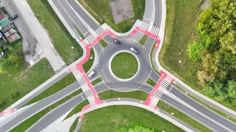 Aerial view of traffic flow at a roundabout intersection showcasing vehicles Stock Footage 325783029