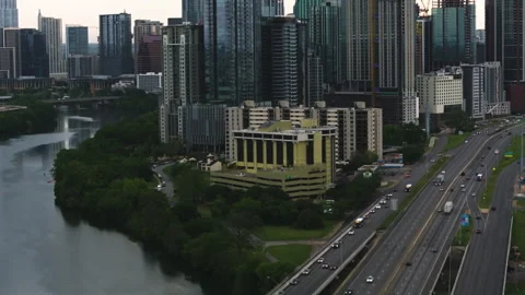 Aerial view of traffic in front of the Austin skyline, moody evening in Stock Footage 278380996