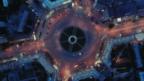Aerial view of traffic at the intersection of a circle. The drone descends to Stock Footage 133357982