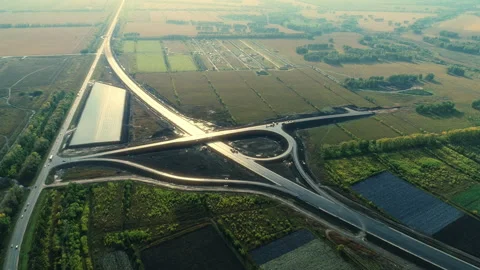 Aerial view of the traffic intersection in the rays of the setting sun Stock Footage 137944690