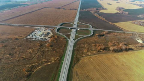 Aerial view of a traffic intersection. Trucks and cars drive along the highway Stock Footage 133634818