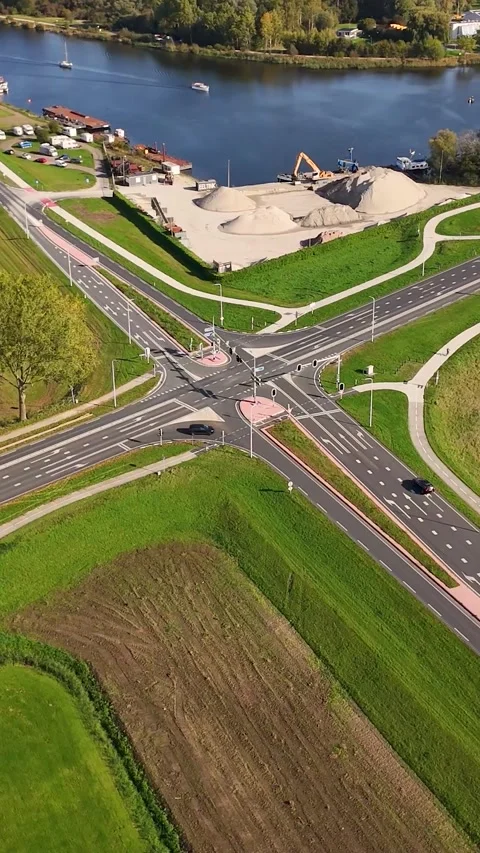 Aerial view of traffic at road intersection next to a river Stock Footage 327108481