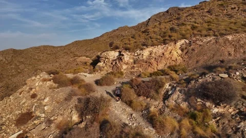 Aerial View of Trail Runner Reaching Mountain Ridge and Raising Arms Stock Footage 345025982