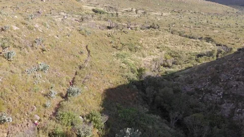 Aerial view of a trail runners running down a mountain Stock-Footage 100771027