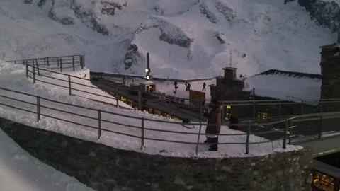 Aerial view of train and couple from Switzerland’s highest peak Stock Footage 173642721