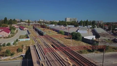 Aerial view of the train approach against the background of the industrial area Stock Footage 80885682