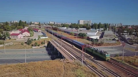 Aerial view of the train approach against the background of the industrial area Stock Footage 80889927