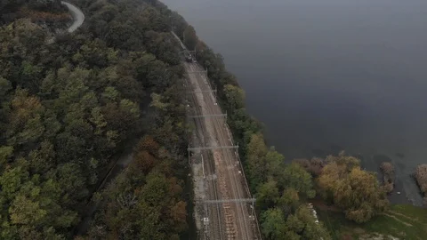 Aerial view of the train between lake and mountain Stock Footage 119505676