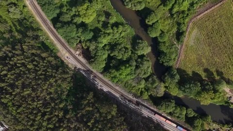 Aerial view of train carrying shipping containers and river, Portugal. Stock Footage 332797236