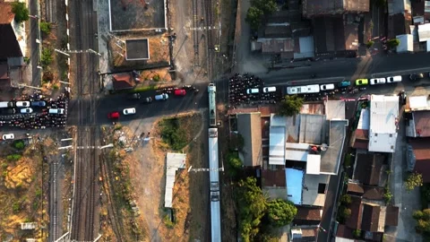 Aerial view of train crossing intersection in Surakarta, Indonesia. Stock Footage 342151380