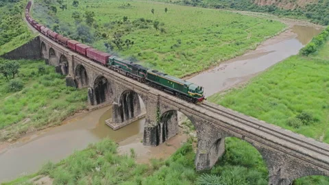 Aerial View of Train Crossing Stone Railway Bridge in Punjab Pakistan Stock Footage 334683039