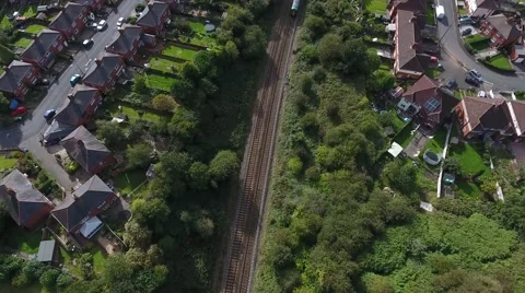 Aerial view of a train going through a housing estate. Stock-Footage 68735744