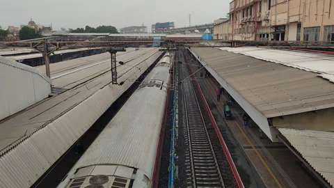 Aerial view of train leaving Vadodara railway station platform, India Stock Footage 345539688