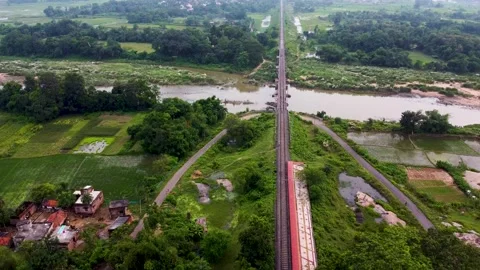Aerial View of Train Line between Farms, Drone Video in India Stock Footage 211137334