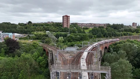 Aerial view Train moving around bend into tunnel 8th August 2024 Gateshead UK Stock Footage 281404848
