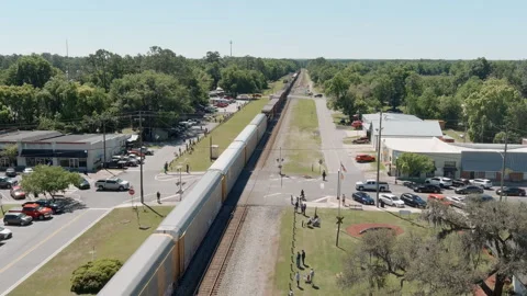 Aerial view of train moving through Folkston, Georgia Stock Footage 276745623